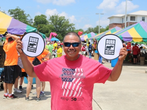 Man holding Durr branded fans