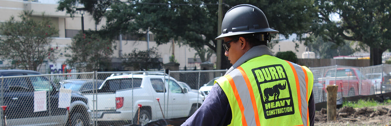 A carpenter wearing a Durr Heavy Construction safety vest