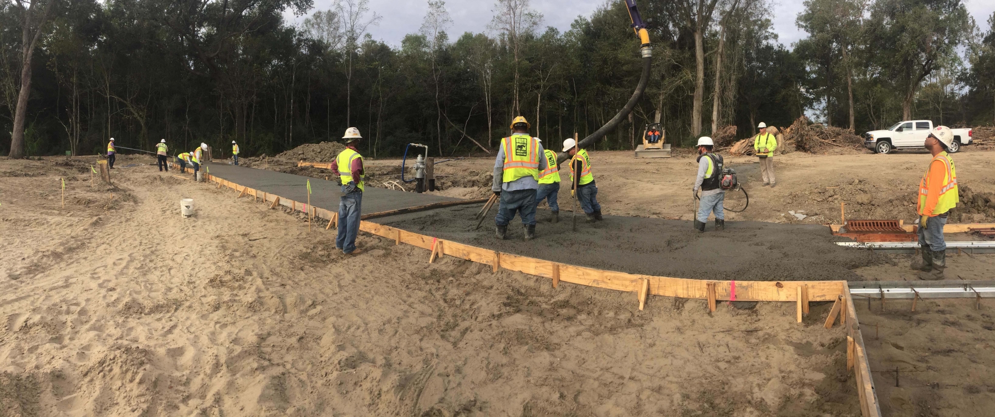 workers smooth out poured concrete
