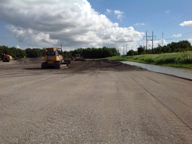 a skidsteer drives across a job site