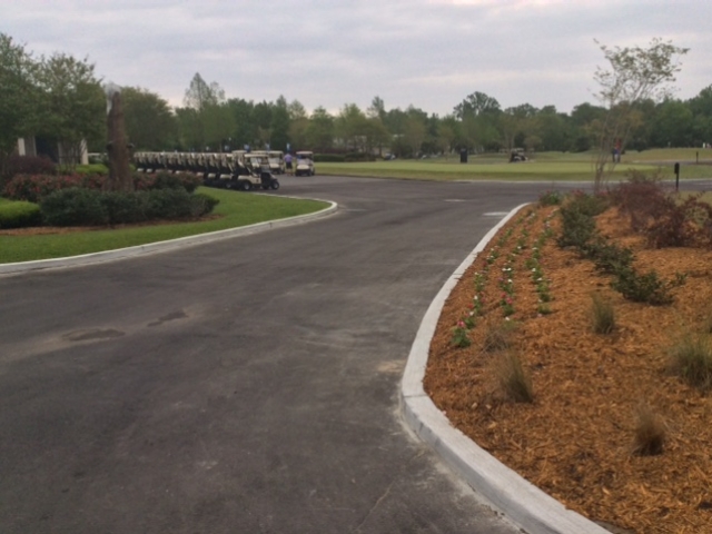 the paved entryway to a parking lot