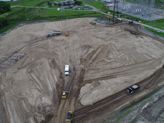Multiple trucks and equipment drive across a jobsite