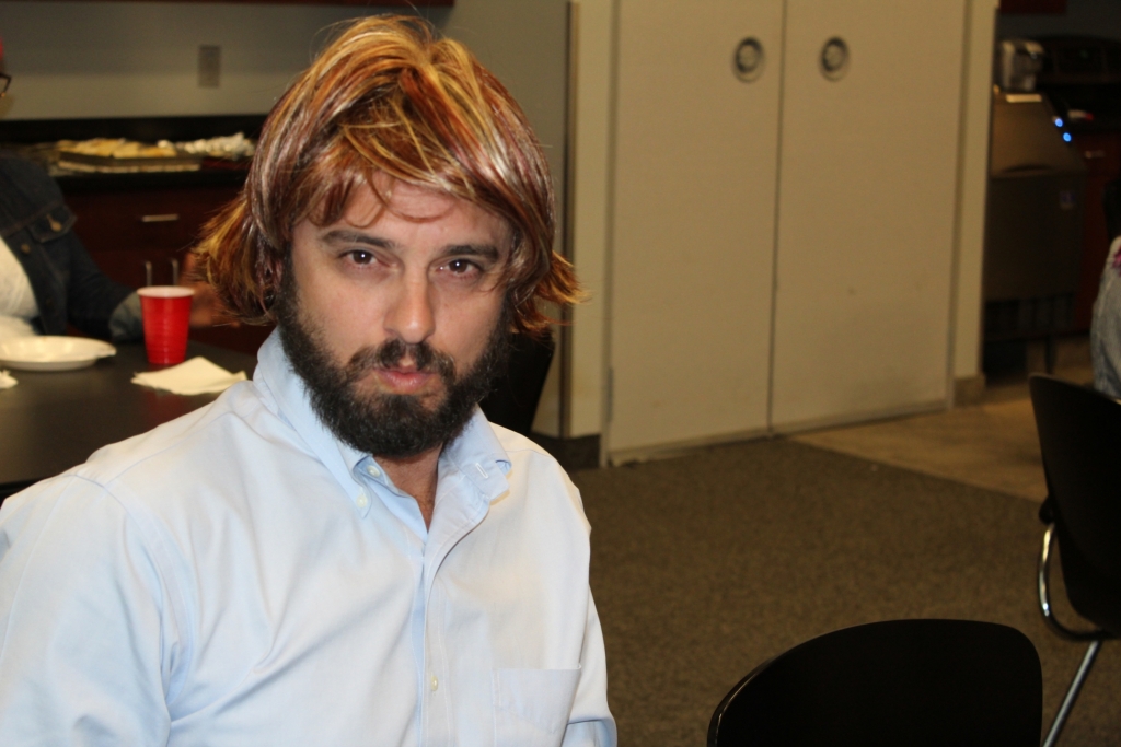 a worker in a wig poses for the camera