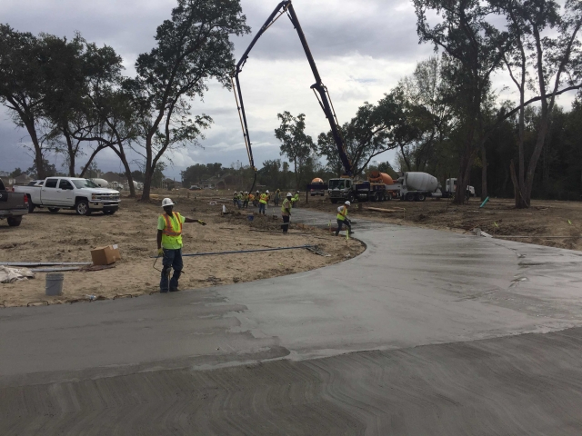 workers lay concrete on a jobsite