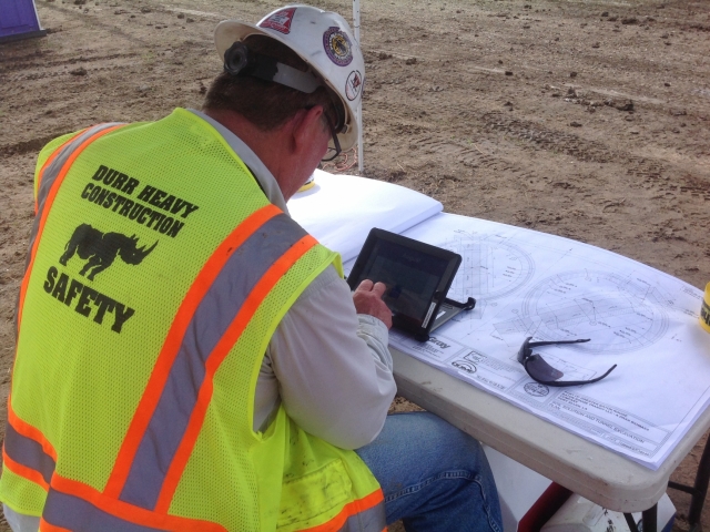 an engineer reviews plans while utilizing an ipad